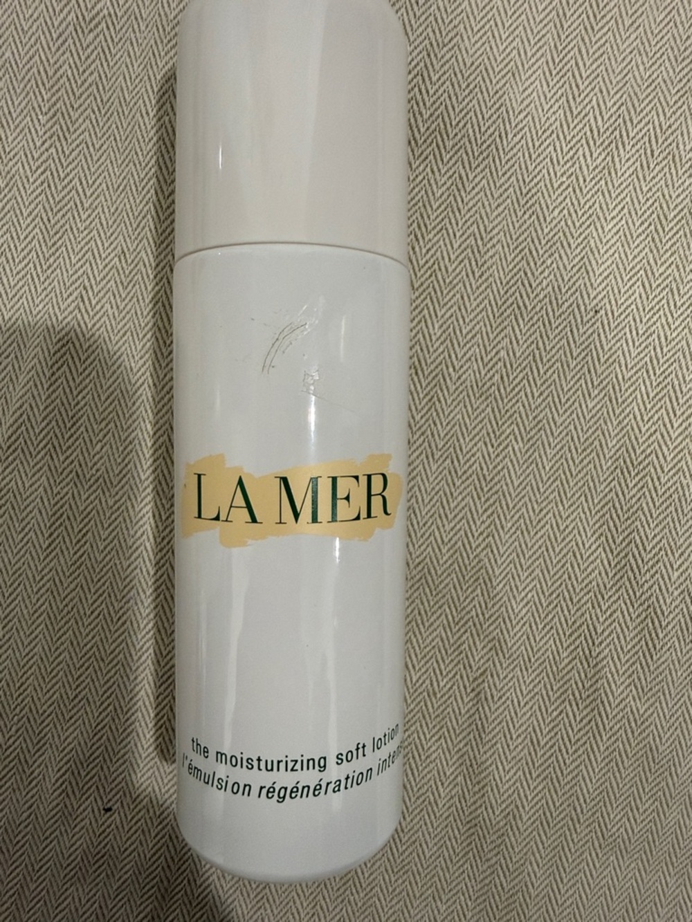 La Mer White Bottle with Gold Accent and Green Logo